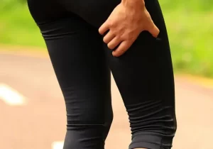 Pessoa com dor na perna devido à ciatalgia durante caminhada