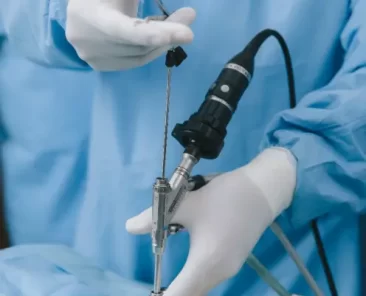 Um médico realiza uma cirurgia de estenose lombar.