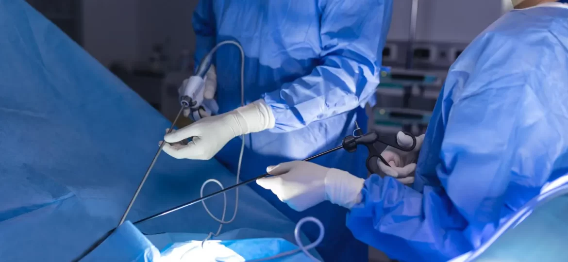 Imagem de dois médicos utilizando endoscópio com câmera, durante a realização de uma endoscopia da coluna.